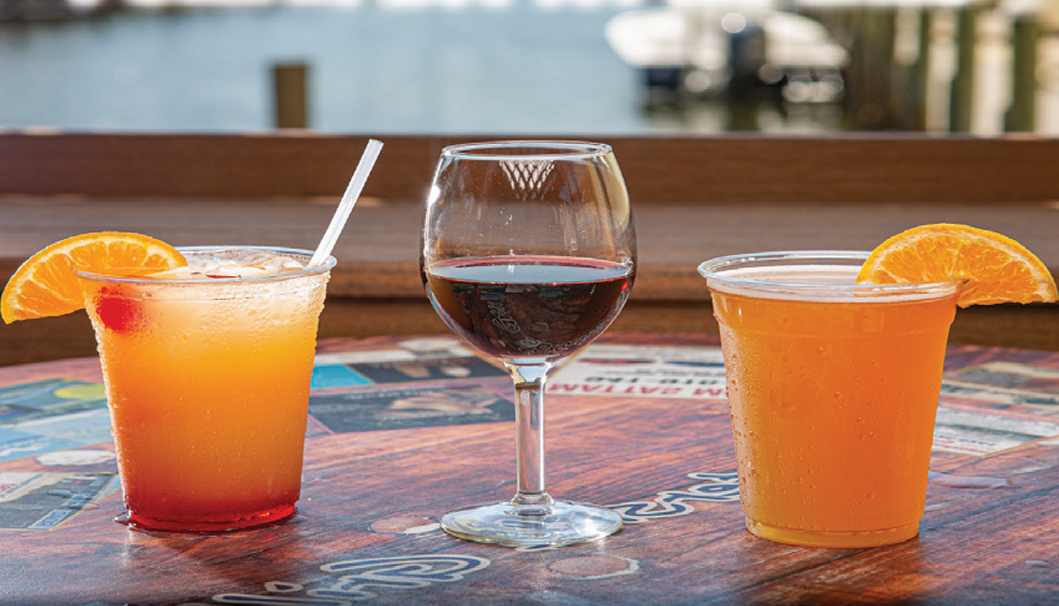 cups of cocktail, wine, and orange juice